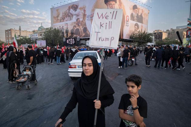 Ayatollah Khamenei™s Funeral In Tehran A pro-government supporter carrying a sign critical of the United States and President Donald Trump participates with her son in the funeral for Iran s late Supreme Leader Ayatollah Ali Khamenei and his family in Tehran, Iran, on July 6, 2026. Tehran Tehran Iran  Copyright: xMortezaxNikoubazlx originalFilename: nikoubazl-ayatolla260706_npQNp.jpg