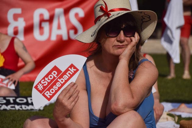 July 7, 2026, London, England, United Kingdom: Climate activists from the group Fossil Free London don swimming costumes and stage a Ã¢â‚¬Ëœsunbathe-inÃ¢â‚¬â ¢ protest dubbed Roast Against Rosebank in Parliament Square calling on the government to stop new North Sea oil and gas projects, as another heatwave hits the UK. London United Kingdom - ZUMAv130 20260707_zip_v130_023 Copyright: xVukxValcicx