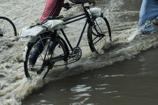 July 7, 2026: Chattogram, Bangladesh - A Bicyle rider navigate a waterlogged street in the Bahaddarhat area of Chattogram on Tuesday, continuing three consecutive days of heavy rainfall. The persistent downpours triggered severe waterlogging across several parts of the port city, submerging roads, disrupting traffic, and causing widespread inconvenience to residents. - ZUMAr143 20260707_zap_r143_002 Copyright: xMdxRafayatxHaquexKhanx