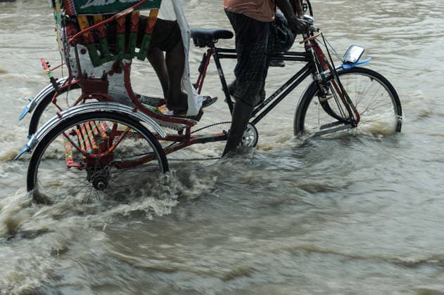 July 7, 2026: Chattogram, Bangladesh - A Rickshaw pullers navigate a waterlogged street in the Bahaddarhat area of Chattogram on Tuesday, continuing three consecutive days of heavy rainfall. The persistent downpours triggered severe waterlogging across several parts of the port city, submerging roads, disrupting traffic, and causing widespread inconvenience to residents. - ZUMAr143 20260707_zap_r143_004 Copyright: xMdxRafayatxHaquexKhanx