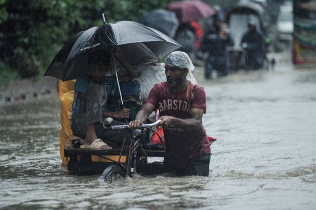 July 7, 2026: Chattogram, Bangladesh - Pedestrians, rickshaw pullers, and commuters navigate a waterlogged street in the Bahaddarhat area of Chattogram on Tuesday, continuing three consecutive days of heavy rainfall. The persistent downpours triggered severe waterlogging across several parts of the port city, submerging roads, disrupting traffic, and causing widespread inconvenience to residents. - ZUMAr143 20260707_zap_r143_005 Copyright: xMdxRafayatxHaquexKhanx