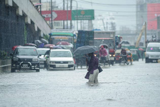 July 7, 2026: Chattogram, Bangladesh - Pedestrians, rickshaw pullers, and commuters navigate a waterlogged street in the Bahaddarhat area of Chattogram on Tuesday, continuing three consecutive days of heavy rainfall. The persistent downpours triggered severe waterlogging across several parts of the port city, submerging roads, disrupting traffic, and causing widespread inconvenience to residents. - ZUMAr143 20260707_zap_r143_006 Copyright: xMdxRafayatxHaquexKhanx