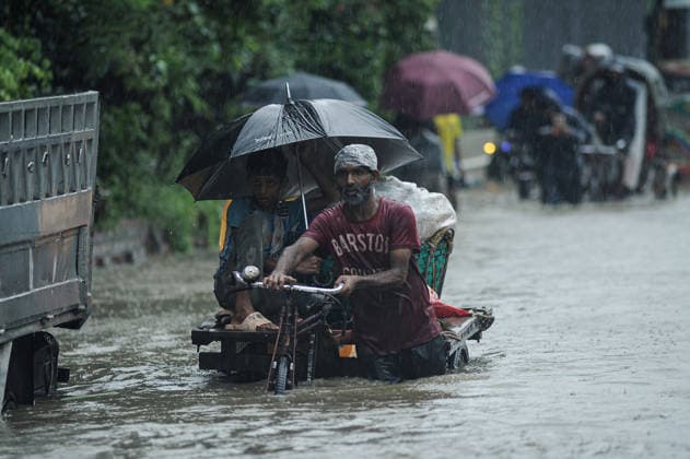 July 7, 2026: Chattogram, Bangladesh - Pedestrians, rickshaw pullers, and commuters navigate a waterlogged street in the Bahaddarhat area of Chattogram on Tuesday, continuing three consecutive days of heavy rainfall. The persistent downpours triggered severe waterlogging across several parts of the port city, submerging roads, disrupting traffic, and causing widespread inconvenience to residents. - ZUMAr143 20260707_zap_r143_007 Copyright: xMdxRafayatxHaquexKhanx