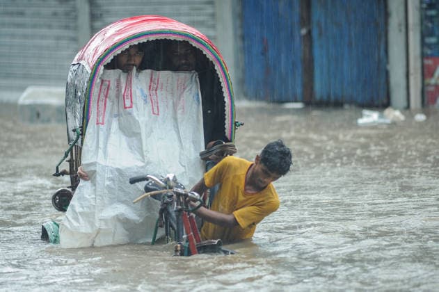 July 7, 2026: Chattogram, Bangladesh - A Rickshaw pullers navigate a waterlogged street in the Bahaddarhat area of Chattogram on Tuesday, continuing three consecutive days of heavy rainfall. The persistent downpours triggered severe waterlogging across several parts of the port city, submerging roads, disrupting traffic, and causing widespread inconvenience to residents. - ZUMAr143 20260707_zap_r143_017 Copyright: xMdxRafayatxHaquexKhanx