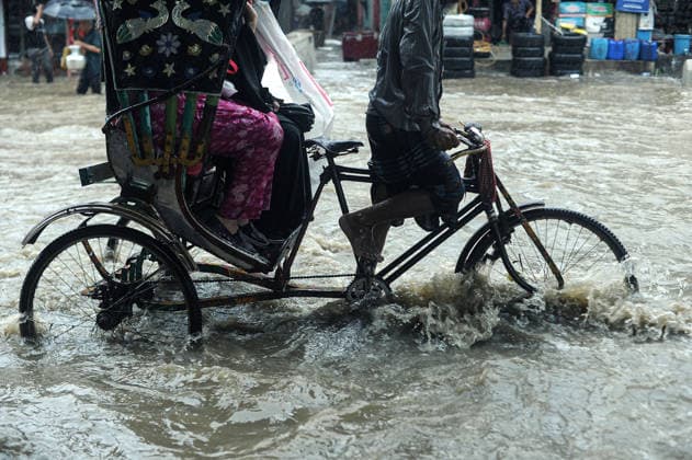 July 7, 2026: Chattogram, Bangladesh - A Rickshaw pullers navigate a waterlogged street in the Bahaddarhat area of Chattogram on Tuesday, continuing three consecutive days of heavy rainfall. The persistent downpours triggered severe waterlogging across several parts of the port city, submerging roads, disrupting traffic, and causing widespread inconvenience to residents. - ZUMAr143 20260707_zap_r143_019 Copyright: xMdxRafayatxHaquexKhanx