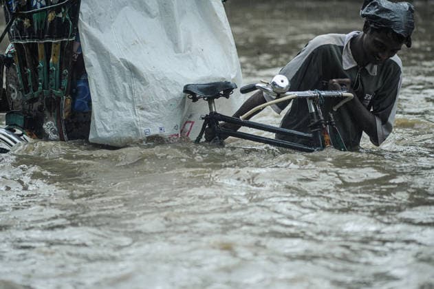 July 7, 2026: Chattogram, Bangladesh - A Rickshaw pullers navigate a waterlogged street in the Bahaddarhat area of Chattogram on Tuesday, continuing three consecutive days of heavy rainfall. The persistent downpours triggered severe waterlogging across several parts of the port city, submerging roads, disrupting traffic, and causing widespread inconvenience to residents. - ZUMAr143 20260707_zap_r143_021 Copyright: xMdxRafayatxHaquexKhanx