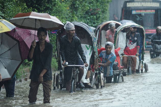 July 7, 2026: Chattogram, Bangladesh - Pedestrians, rickshaw pullers, and commuters navigate a waterlogged street in the Bahaddarhat area of Chattogram on Tuesday, continuing three consecutive days of heavy rainfall. The persistent downpours triggered severe waterlogging across several parts of the port city, submerging roads, disrupting traffic, and causing widespread inconvenience to residents. - ZUMAr143 20260707_zap_r143_025 Copyright: xMdxRafayatxHaquexKhanx