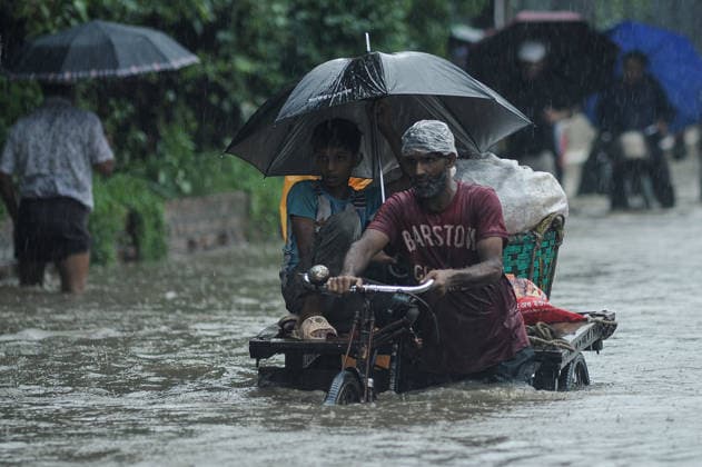 July 7, 2026: Chattogram, Bangladesh - Pedestrians, rickshaw pullers, and commuters navigate a waterlogged street in the Bahaddarhat area of Chattogram on Tuesday, continuing three consecutive days of heavy rainfall. The persistent downpours triggered severe waterlogging across several parts of the port city, submerging roads, disrupting traffic, and causing widespread inconvenience to residents. - ZUMAr143 20260707_zap_r143_028 Copyright: xMdxRafayatxHaquexKhanx