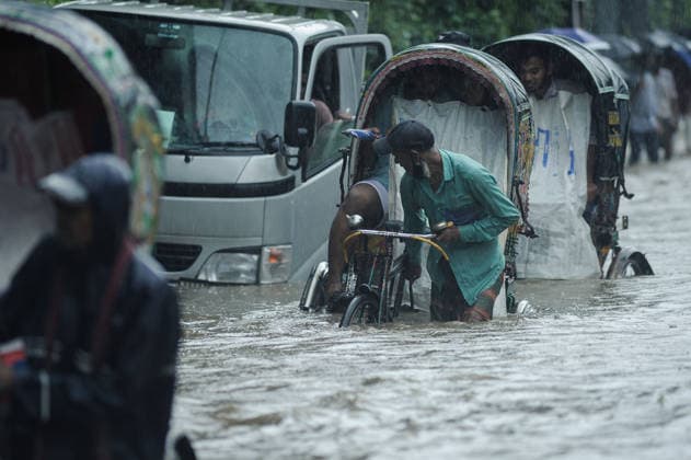 July 7, 2026: Chattogram, Bangladesh - Pedestrians, rickshaw pullers, and commuters navigate a waterlogged street in the Bahaddarhat area of Chattogram on Tuesday, continuing three consecutive days of heavy rainfall. The persistent downpours triggered severe waterlogging across several parts of the port city, submerging roads, disrupting traffic, and causing widespread inconvenience to residents. - ZUMAr143 20260707_zap_r143_031 Copyright: xMdxRafayatxHaquexKhanx