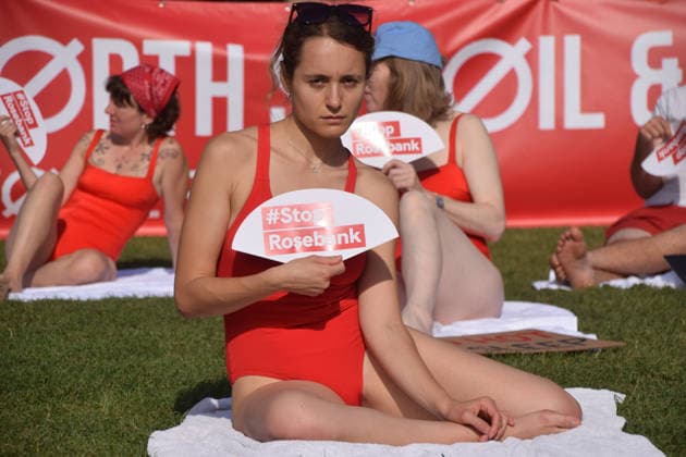 July 7, 2026, London, England, United Kingdom: Climate activists from the group Fossil Free London don swimming costumes and stage a Ã¢â‚¬Ëœsunbathe-inÃ¢â‚¬â ¢ protest dubbed Roast Against Rosebank in Parliament Square calling on the government to stop new North Sea oil and gas projects, as another heatwave hits the UK. London United Kingdom  - ZUMAv130 20260707_zip_v130_033 Copyright: xVukxValcicx