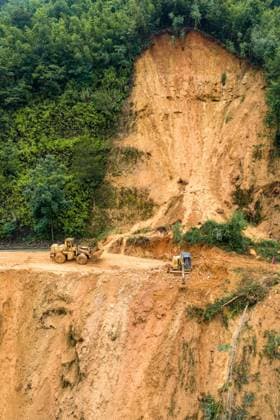 (260707) -- LAIBIN, July 7, 2026 -- An aerial drone photo taken on July 7, 2026 shows emergency restoration of a damaged highway in Qingshan Village of Jinxiu Yao Autonomous County, Laibin City, south China s Guangxi Zhuang Autonomous Region. Recent extreme rainstorms triggered by Typhoon Maysak, the 10th typhoon of the year, have caused severe flooding in parts of south China s Guangxi Zhuang Autonomous Region. Traffic of several national and provincial highways in Jinxiu Yao Autonomous County has been disrupted. Emergency restoration of the damaged roads is underway. (Photo by Xinhua) (SpotNews) CHINA-GUANGXI-LAIBIN-TYPHOON-DAMAGED ROADS (CN) GaoxRujin 