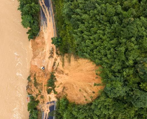 (260707) -- LAIBIN, July 7, 2026 -- An aerial drone photo taken on July 7, 2026 shows emergency restoration of a damaged highway in Qingshan Village of Jinxiu Yao Autonomous County, Laibin City, south China s Guangxi Zhuang Autonomous Region. Recent extreme rainstorms triggered by Typhoon Maysak, the 10th typhoon of the year, have caused severe flooding in parts of south China s Guangxi Zhuang Autonomous Region. Traffic of several national and provincial highways in Jinxiu Yao Autonomous County has been disrupted. Emergency restoration of the damaged roads is underway. (Photo by Xinhua) (SpotNews) CHINA-GUANGXI-LAIBIN-TYPHOON-DAMAGED ROADS (CN) GaoxRujin 