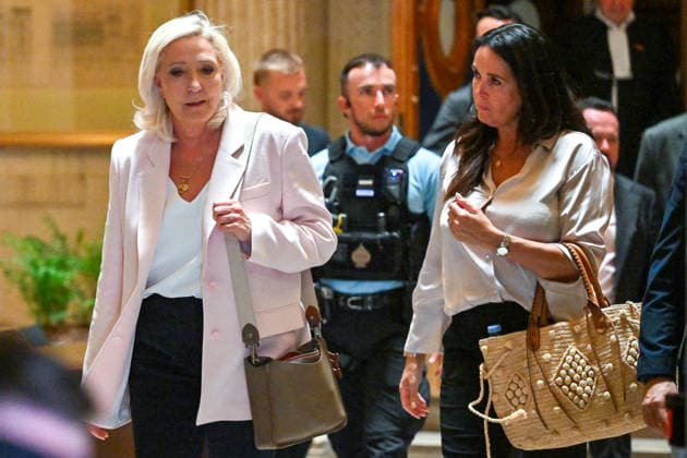 Marine Le Pen, president of the National Rally, accompanied by Member of the European Parliament Catherine Griset, leaves the Paris Court of Appeals, France, on July 7, 2026, following the verdict in the appeal trial of former and current RN members accused of embezzling European public funds in a case involving the creation of fictitious jobs at the European Parliament. The Court of Appeals sentenced Marine Le Pen, leader of the French far right, to one year of house arrest with an electronic ankle monitor in connection with this case, thereby jeopardizing her presidential candidacy next April. She was also barred from running for office for 15 months, a ban that was set to expire this year. Christian Liewig Bestimage President of the Ras  Copyright: xChristianxLiewigx xBestimagexChristianxLiewigx xBestimagex