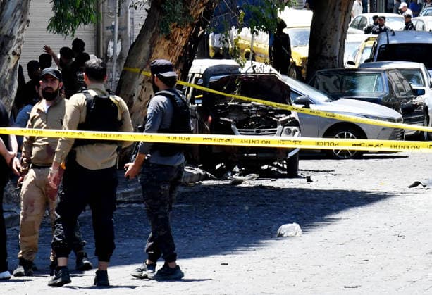 (260707) -- DAMASCUS, July 7, 2026 -- Security personnel cordon off the area around the blast site near the Ministry of Tourism building in central Damascus, Syria, July 7, 2026. Two explosions in central Damascus on Tuesday injured 18 people during a visit by French President Emmanuel Macron, according to Syria s Interior Ministry. (Photo by Xinhua) SYRIA-DAMASCUS-EXPLOSIONS AmmarxSafarjalani 