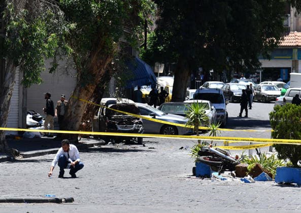 (260707) -- DAMASCUS, July 7, 2026 -- Security personnel cordon off the area around the blast site near the Ministry of Tourism building in central Damascus, Syria, July 7, 2026. Two explosions in central Damascus on Tuesday injured 18 people during a visit by French President Emmanuel Macron, according to Syria s Interior Ministry. (Photo by Xinhua) SYRIA-DAMASCUS-EXPLOSIONS AmmarxSafarjalani 