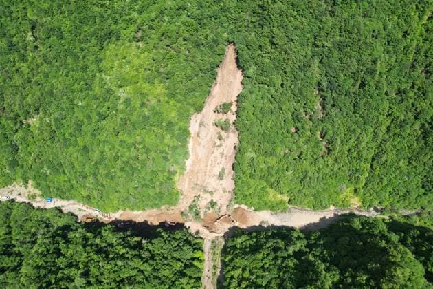 (260707) -- TANCHANG, July 7, 2026 -- An aerial drone photo taken on July 7, 2026 shows the site of a landslide in a village in Nanhe Township, Tanchang County, Longnan City, northwest China s Gansu Province. China s Ministry of Emergency Management activated a Level-IV national emergency response for geological disasters in northwest China s Gansu Province and dispatched a working team to guide rescue and relief efforts after a landslide struck a village on Tuesday, leaving multiple people buried and dead. The landslide occurred at around 6:56 a.m. in a village in Nanhe Township, Tanchang County, Longnan City, according to local authorities. A total of 33 people were buried beneath the debris. As of 2:50 p.m., 21 people had been p 