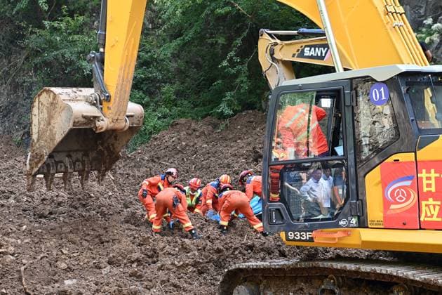 (260707) -- TANCHANG, July 7, 2026 -- Rescuers work at the site of a landslide in a village in Nanhe Township, Tanchang County, Longnan City, northwest China s Gansu Province, July 7, 2026. China s Ministry of Emergency Management activated a Level-IV national emergency response for geological disasters in northwest China s Gansu Province and dispatched a working team to guide rescue and relief efforts after a landslide struck a village on Tuesday, leaving multiple people buried and dead. The landslide occurred at around 6:56 a.m. in a village in Nanhe Township, Tanchang County, Longnan City, according to local authorities. A total of 33 people were buried beneath the debris. As of 2:50 p.m., 21 people had been pulled from the debr 