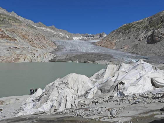 07.07.26 Schweiz Wallis, Tourismus,TourismusbrancheGletscherschmelze. Bild, Rhonegletscher mit Gletschersee.Wanderer vor Eisgrotte,ist mit Textilplanen abgedeckt. *** 07 07 26 Switzerland, Valais, Tourism, Tourism Industry, Glacier Melt Image, Rhône Glacier with glacial lake, Hiker in front of an ice grotto, covered with tarps 