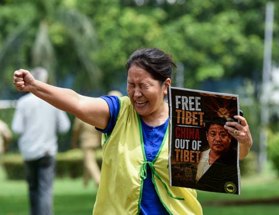 TYC Protests Near the Chinese Embassy in New Delhi New Delhi, Jul 07 (ANI): A Tibetan Youth Congress (TYC) supporter holds a poster and raises slogans during the party s protest over their various demands near the Chinese Embassy, in New Delhi on Tuesday. NEW DELHI Delhi India Copyright: xANIx ANI_20260707062