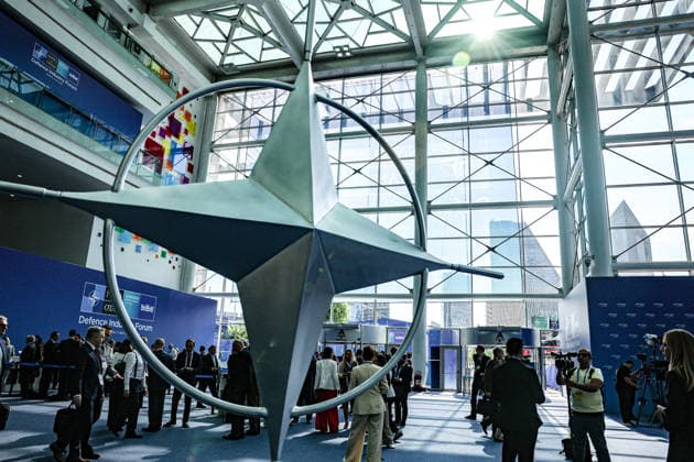July 7, 2026, Ankara, Turkiye, Turkiye: Delegates and media personnel gather around a massive rotating steel NATO compass rose emblem in the main atrium of the ATO Congresium during the NATO Summit Defence Industry Forum (NSDIF). The flagship forum brought together alliance leaders, defence ministers, and global aerospace executives to finalize more than 70 billion USD in joint procurement contracts aimed at streamlining transatlantic weapons manufacturing and production scaling Ankara Turkiye - ZUMAo116 20260707_znp_o116_037 Copyright: xBiancaxOterox
