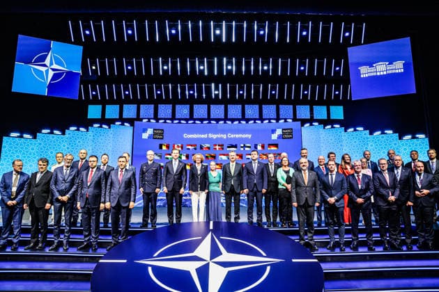 July 7, 2026, Ankara, Turkiye, Turkiye: NATO Deputy Secretary General RADMILA SEKERINSKA (C in black jacket), President of the Turkish Secretariat of Defence Industries HALUK GORGUN (CR in black jacket), Roketsan stand on stage for a family photo alongside international defence ministers, foreign affairs delegates, and corporate executives during the Combined Signing Ceremony at the NATO Summit Defence Industry Forum (NSDIF) at the ATO Congresium. The wide group assembly, set against a digital background displaying allied national flags, marked the finalisation of a monumental multi-billion dollar transatlantic investment package coordinating multi-layered air defence shields, precision munitions, and strategic space surveillance infrastruc  - ZUMAo116 20260707_znp_o116_045 Copyright: xBiancaxOterox