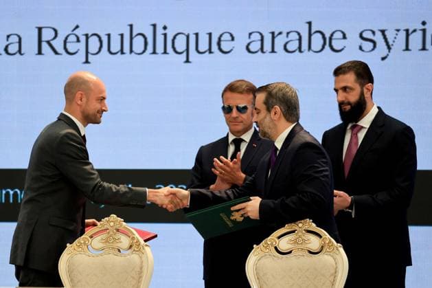 President Macron Visits Syria - Economic Forum France s Foreign Affairs Minister Jean-Noel Barrot (L) and Syria s Foreign Minister Asaad al-Shaibani (2nd R) shake hands flanked by France s President Emmanuel Macron (2nd L) and Syria s Foreign Minister Asaad al-Shaibani after signing the Framework Agreement on Bilateral Cooperation during an agreement signing ceremony in Damascus on July 7, 2026. French President Emmanuel Macron arrived in Damascus on July 6, 2026 for the first visit by a Western European head of state since Syria s new authorities took power in 2024, an AFP journalist said. Macron, who will depart on July 7, 2026, will advocate for a free, pluralist Syria that respects each of its components and plays a role in moderating  Copyright: xMarinxLudovic Pool ABACAx