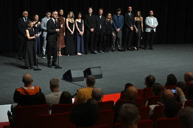 The 60th Karlovy Vary International Film Festival continued on its fifth day, in Karlovy Vary, Czech Republic, on July 7, 2026. A delegation of filmmakers presented the competition film Three Weeks Later (Serbia, Bulgaria, Italy, Croatia, Luxembourg) in the Grand Ballroom of the Thermal Hotel. Director Miroslav Terzic is standing backward left (wearing glasses and a goatee beard), in front of him stands interpreter of the Karlovy Vary Festival Helena Koutna. (CTKxPhoto SlavomirxKubes) CTKPhotoP2026070709546  CTKPhotoP2026070709546