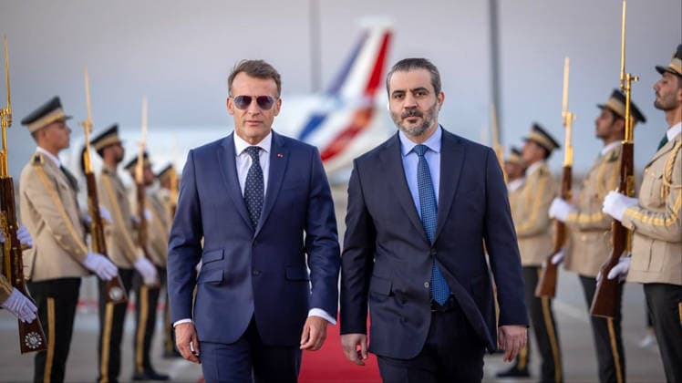 France s President Emmanuel Macron (L) is welcomed by Syria s Foreign Minister Asaad al-Shaibani (R) as he arrives for a state visit at the Damascus International Airport in Damascus in Syria, on Tuesday, July 7, 2026. Security sources reported that more than 15 people were injured in an explosion at a café in central Damascus, as French leader Emmanuel Macron made the first post-conflict visit to Damascus by a Western European leader.  SYR2026070709 SyrianxMinistryxofxForeignxAffai