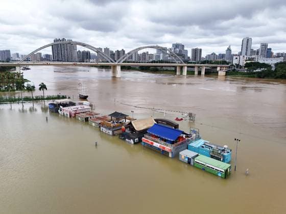 NANNING, CHINA - JULY 07: Floodwaters submerge riverside walkways and shops on July 7, 2026 in Nanning, Guangxi Zhuang Autonomous Region of China. Recent extreme rainstorms triggered by Typhoon Maysak, the 10th typhoon of the year, have caused severe flooding in parts of south China s Guangxi Zhuang Autonomous Region.  Copyright: xVCGx 111652813944