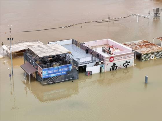 NANNING, CHINA - JULY 07: Floodwaters submerge riverside walkways and shops on July 7, 2026 in Nanning, Guangxi Zhuang Autonomous Region of China. Recent extreme rainstorms triggered by Typhoon Maysak, the 10th typhoon of the year, have caused severe flooding in parts of south China s Guangxi Zhuang Autonomous Region.  Copyright: xVCGx 111652813952