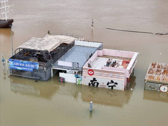 NANNING, CHINA - JULY 07: Floodwaters submerge riverside walkways and shops on July 7, 2026 in Nanning, Guangxi Zhuang Autonomous Region of China. Recent extreme rainstorms triggered by Typhoon Maysak, the 10th typhoon of the year, have caused severe flooding in parts of south China s Guangxi Zhuang Autonomous Region.  Copyright: xVCGx 111652813954