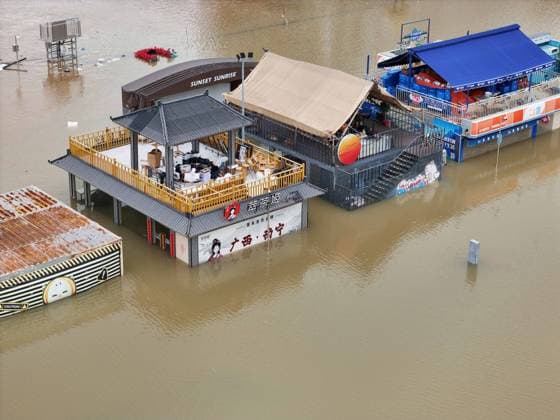 NANNING, CHINA - JULY 07: Floodwaters submerge riverside walkways and shops on July 7, 2026 in Nanning, Guangxi Zhuang Autonomous Region of China. Recent extreme rainstorms triggered by Typhoon Maysak, the 10th typhoon of the year, have caused severe flooding in parts of south China s Guangxi Zhuang Autonomous Region.  Copyright: xVCGx 111652813955
