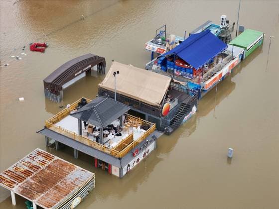 NANNING, CHINA - JULY 07: Floodwaters submerge riverside walkways and shops on July 7, 2026 in Nanning, Guangxi Zhuang Autonomous Region of China. Recent extreme rainstorms triggered by Typhoon Maysak, the 10th typhoon of the year, have caused severe flooding in parts of south China s Guangxi Zhuang Autonomous Region.  Copyright: xVCGx 111652813956