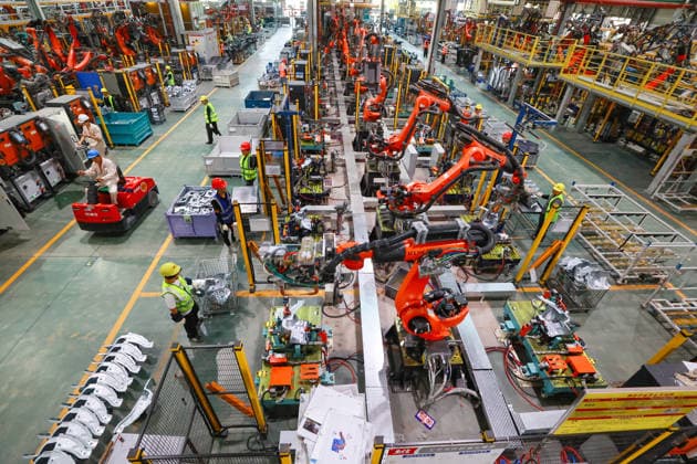 JINHUA, CHINA - JULY 07: Industrial robots operate while workers produce new energy vehicle parts at a workshop of Jinhua Zhixin Technology Co., Ltd. on July 7, 2026 in Jinhua, Zhejiang Province of China.  Copyright: xVCGx 111652834350