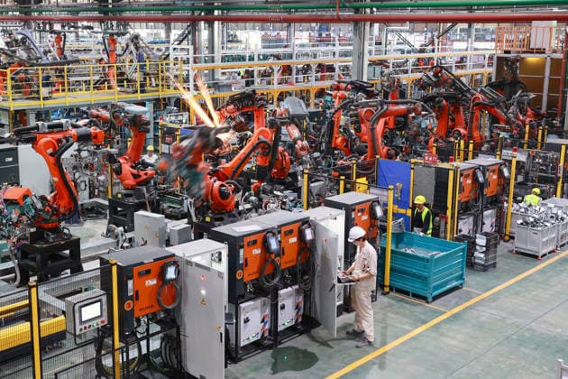 JINHUA, CHINA - JULY 07: Workers and industrial robots produce new energy vehicle parts at the workshop of Jinhua Zhixin Technology Co., Ltd. on July 7, 2026 in Jinhua, Zhejiang Province of China. The factory is ramping up production to fulfill orders for new energy vehicle components.  Copyright: xVCGx 111652834351