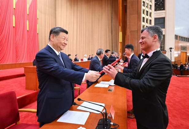 (260708) -- BEIJING, July 8, 2026 -- Xi Jinping and other leaders of the Communist Party of China and the state, together with the two winners of the national top sci-tech award, present certificates to representatives of recipients of the State Natural Science Award, the State Technological Invention Award, the State Scientific and Technological Progress Award and the China International Science and Technology Cooperation Award at the Great Hall of the People in Beijing, capital of China, July 8, 2026. A meeting bringing together the national science and technology award conference, the general assemblies of the members of the Chinese Academy of Sciences (CAS) and the Chinese Academy of Engineering (CAE), and the 11th national congress of 