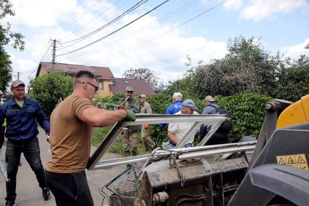 RECORD DATE NOT STATED Men clear debris and building rubble following the overnight Russian attack of July 6, Vyshneve, Kyiv region, Ukraine, on July 7, 2026. Russian forces launched a massive attack on Kyiv and the surrounding region using various types of missiles and attack drones. According to the State Emergency Service of Ukraine, seven people were killed in Vyshneve. Residential development on five streets was completely destroyed, while warehouses and businesses sustained damage. More than 600 local residents were evacuated because of the risk posed by unexploded ordnance (Photo by Volodymyr Tarasov Ukrinform) Aftermath of Russian attack and secondary explosions cleared in Vyshneve  Copyright: xVolodymyrxTarasovx