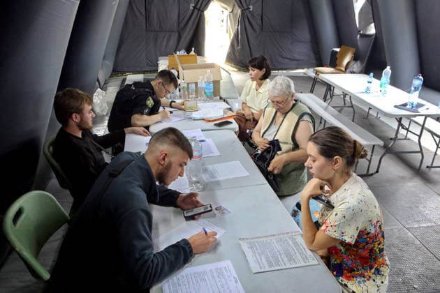 RECORD DATE NOT STATED Aftermath Of Russian Attack In Vyshneve - Ukraine Police officers receive property damage reports at a tent of the State Emergency Service of Ukraine during recovery operations following a combined Russian attack and secondary explosions of explosive ordnance, Vyshneve, Kyiv region, Ukraine, on July 7, 2026. During the night of July 6, Russian forces launched a massive attack on Kyiv and the surrounding region using various types of missiles and attack drones. According to the State Emergency Service of Ukraine, seven people were killed in Vyshneve. Residential development on five streets was completely destroyed, while warehouses and businesses sustained damage. More than 600 local residents were evacuated because of the risk posed by unex  Copyright: xTarasovxVolodymyr Ukrinform ABACAx
