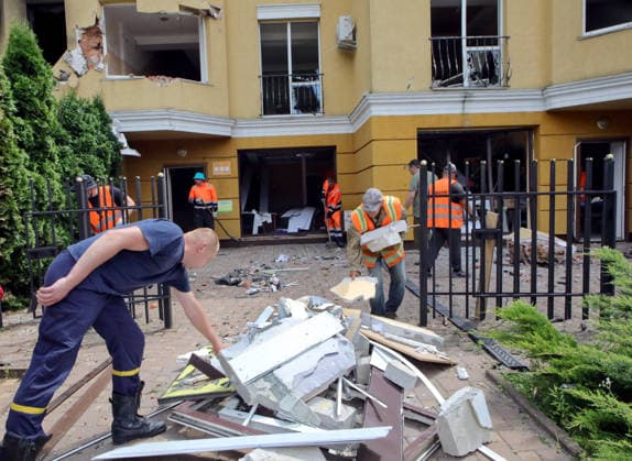 RECORD DATE NOT STATED Aftermath Of Russian Attack In Vyshneve - Ukraine Municipal workers clean the grounds of a house damaged by the overnight Russian attack of July 6 in Vyshneve, Kyiv region, Ukraine, on July 7, 2026. Russian forces launched a massive attack on Kyiv and the surrounding region using various types of missiles and attack drones. According to the State Emergency Service of Ukraine, seven people were killed in Vyshneve. Residential development on five streets was completely destroyed, while warehouses and businesses sustained damage. More than 600 local residents were evacuated because of the risk posed by unexploded ordnance Photo by Volodymyr Tarasov Ukrinform ABACAPRESS.COM Kyiv region Ukraine  Copyright: xTarasovxVolodymyr Ukrinform ABACAx