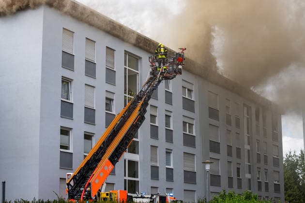 Wohnungsbrand greift auf Dachstuhl über Dach auf 60 mal 10 Metern in Vollbrand Am 08.07.2026 kam es in Frankfurt-Schwanheim gegen 15:50 Uhr zu einem Wohnungsbrand im dritten Obergeschoss eines Mehrfamilienhauses, der noch vor Eintreffen der Feuerwehr auf den Dachstuhl übergriff. Die Berufsfeuerwehr und die Freiwillige Feuerwehr Frankfurt bekämpften den Dachbrand auf einer Fläche von 60 mal 10 Metern mit acht Rohren vom Boden sowie über vier Drehleitern. Aufgrund der Thermik zog der Rauch nicht ab, sondern breitete sich über umliegende Straßen aus, weshalb die Polizei per Lautsprecher zum Schließen von Fenstern und Türen aufrief und zusätzlich über Medien gewarnt wurde. Die Brandwohnung brannte komplett aus und ist nicht mehr