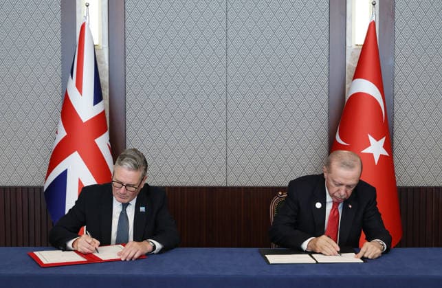 Britain s Prime Minister Keir Starmer, left, and Turkish President Recep Tayyip Erdogan sign a defense partnership agreement on the sidelines of the NATO summit in Ankara, Turkey, Wednesday, July 8, 2026.  TUR2026070834 TurkishxPresidencyxOffice