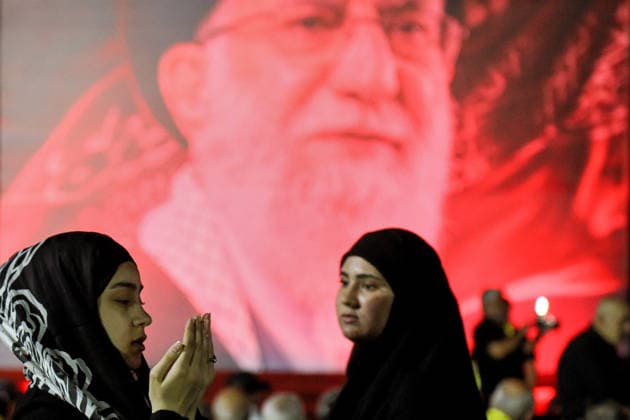 July 8, 2026, Beirut, Beirut, Lebanon: A pro-Iranian Hezbollah supporter performs dusk prayer in front of a poster of assassinated Iranian Supreme Leader Ayatollah Ali Khamenei during a memorial ceremony mourning the Iranian slain chief in Beirut southern suburb. Iran began six days of public funeral ceremonies for Khamenei on July 4, including a dedicated day to neighboring Iraq, a Shia powerhouse with close ties to Tehran. Beirut Lebanon - ZUMAn313 20260708_zip_n313_012 Copyright: xMarwanxNaamanix