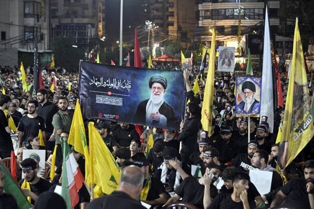 Symbolic funeral ceremony held in Beirut for Iran s late Supreme Leader Khamenei BEIRUT, LEBANON - JULY 8: People, holding photos of Khamenei, Lebanese and Iranian flags, and Hezbollah banners, attend a symbolic funeral ceremony for Iran s late Supreme Leader Ayatollah Ali Khamenei in Dahieh district of Beirut, Lebanon on July 8, 2026. Houssam Shbaro Anadolu Beirut Lebanon. Editorial use only. Please get in touch for any other usage.  Copyright: x2026xAnadoluxHoussamxShbarox