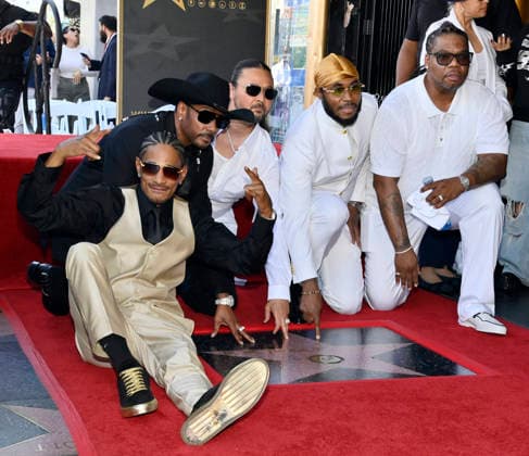 Layzie Bone, Krayzie Bone, Bizzy Bone, Flesh-n-Bone and Wish Bone (L-R) of the Hip-Hop group Bone Thugs-N-Harmony gather around their star during a ceremony honoring them with the 2,851st star on the Hollywood Walk of Fame in Los Angeles on Wednesday, July 8, 2026.  LAP2026070803 JIMxRUYMEN