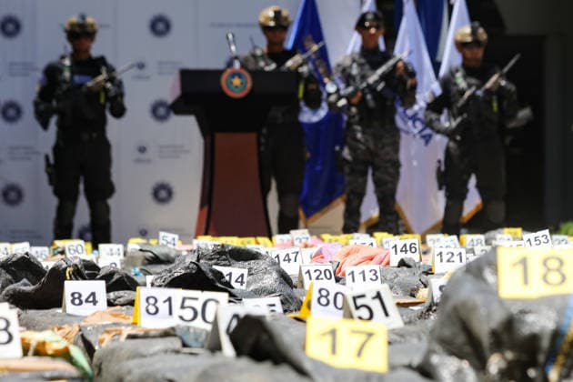 Salvadoran Security Authorities Present Seized Drug Shipment LA PAZ, EL SALVADOR - JULY 08: Police officers guarding packages of drugs marked as evidence during the presentation of a drug shipment seized at sea by Salvadoran security authorities, at the Port Captaincy of La Concordia on the Costa del Sol, La Paz, El Salvador on July 08, 2026. Salvadoran President Nayib Bukele reported on his social media that on June 18, members of the Salvadoran National Navy seized 6.68 tons of drugs more than 600 nautical miles offshore, valued at $167 million. Alex Pena Anadolu La Paz El Salvador. Editorial use only. Please get in touch for any other usage.  Copyright: x2026xAnadoluxAlexxPenax