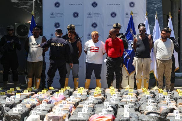 Salvadoran Security Authorities Present Seized Drug Shipment LA PAZ, EL SALVADOR - JULY 08: Police officers guarding foreigners captured with drug packages during the presentation of a drug shipment seized at sea by Salvadoran security authorities, at the Port Captaincy of La Concordia on the Costa del Sol, La Paz, El Salvador on July 08, 2026. Salvadoran President Nayib Bukele reported on his social media that on June 18, members of the Salvadoran National Navy seized 6.68 tons of drugs more than 600 nautical miles offshore, valued at $167 million. Alex Pena Anadolu La Paz El Salvador. Editorial use only. Please get in touch for any other usage.  Copyright: x2026xAnadoluxAlexxPenax