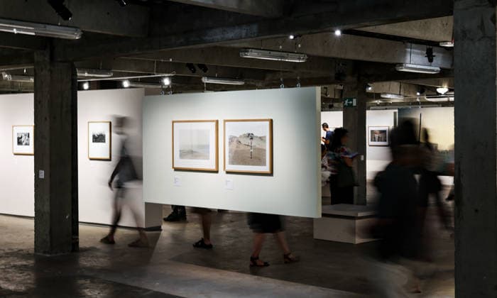 (260709) -- ARLES, July 9, 2026 -- People view exhibits during an exhibition at the Rencontres d Arles photography festival in Arles, France, July 8, 2026. The 57th Rencontres d Arles photography festival lasts from July 6 to October 4. ) FRANCE-ARLES-RENCONTRES D ARLES-PHOTOGRAPHY FESTIVAL-EXHIBITION WuxHuiwo 