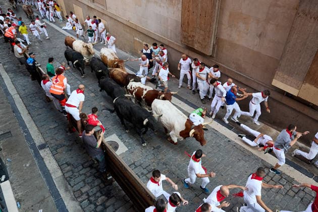 July 9, 2026, Pamplona, Navarre, Spain: People take part in the traditional encierro (bull-run) of the San Fermin Festival in Pamplona, Spain on July 09, 2026. The bull-running fiesta is held annually from 06 to 14 July in commemoration of the city s patron saint. Visitors from all over the world attend the festival. Many of them physically participate in the highlight event - the running of the bulls, or encierro - where they attempt to outrun the animals along a route through the narrow streets of Pamplona s old city. Pamplona Spain - ZUMAa206 20260709_zsp_a206_001 Copyright: xRubenxAlbarranx