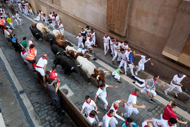 July 9, 2026, Pamplona, Navarre, Spain: People take part in the traditional encierro (bull-run) of the San Fermin Festival in Pamplona, Spain on July 09, 2026. The bull-running fiesta is held annually from 06 to 14 July in commemoration of the city s patron saint. Visitors from all over the world attend the festival. Many of them physically participate in the highlight event - the running of the bulls, or encierro - where they attempt to outrun the animals along a route through the narrow streets of Pamplona s old city. Pamplona Spain - ZUMAa206 20260709_zsp_a206_005 Copyright: xRubenxAlbarranx