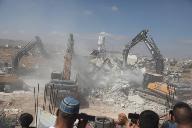 Israeli forces demolish home in southern West Bank town of Yatta Israeli forces demolish the two-story home of Palestinian resident Iyad Musleh al-Amour in the Khallet al-Miyeh area, east of the town of Yatta, south of Hebron in the occupied West Bank, on July 9, 2026. The house was home to three families comprising 15 people. According to local residents, the demolition was carried out on the grounds that the building lacked a permit, leaving the families displaced. Photo by Mamoun Wazwaz apaimages Hebron West Bank Palestinian Territory 090726_Hebron_MW_00(4) Copyright: xapaimagesxMamounxWazwazx xapaimagesx